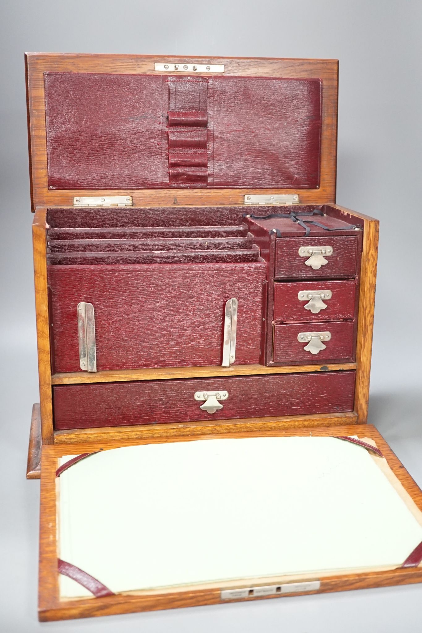 An Edwardian Morocco leather lined oak stationery box and letter rack 36cm